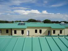 Steel buildings with green roofs and ivory-white walls