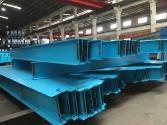 Light-blue painted steel members stored in a workshop