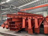Red painted steel beams stored in a workshop