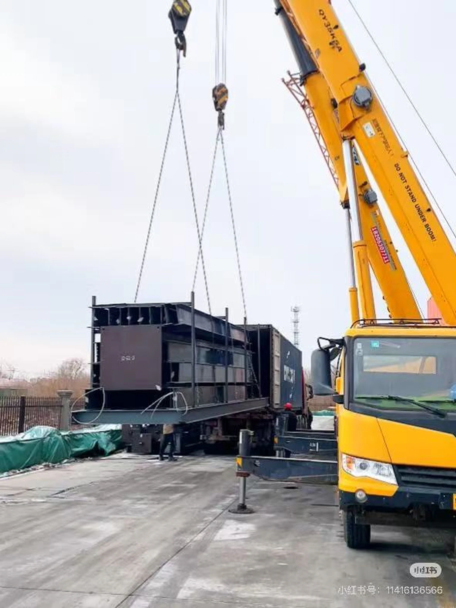 Packing rack being lifted beside a container