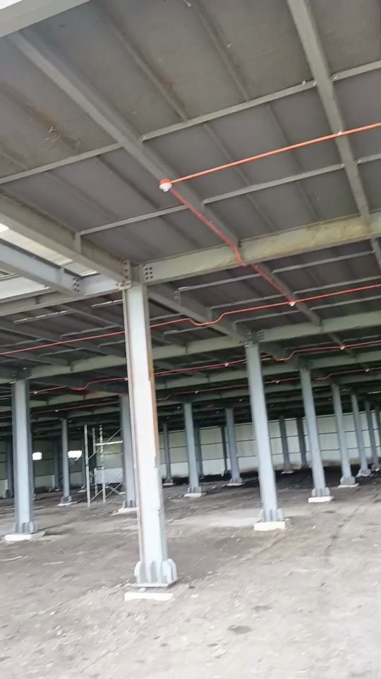 Ground floor view of steel warehouse with roof skylights and steel columns