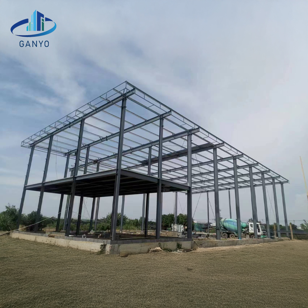 Steel frame erection stage with columns beams and roof purlins visible in the Thailand workshop project