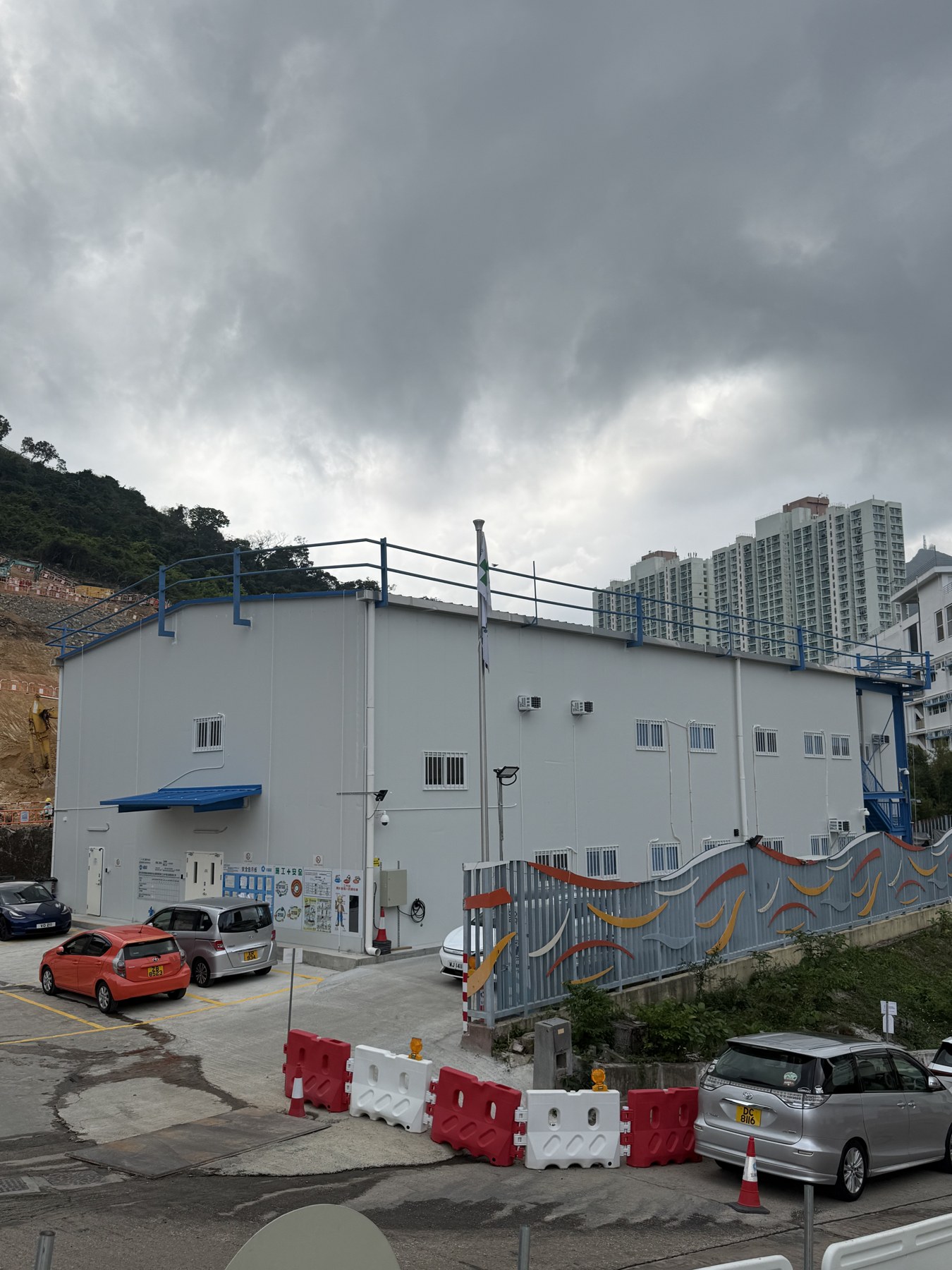 Finished front view of the Hong Kong Chai Wan steel structure office building in an urban hillside setting