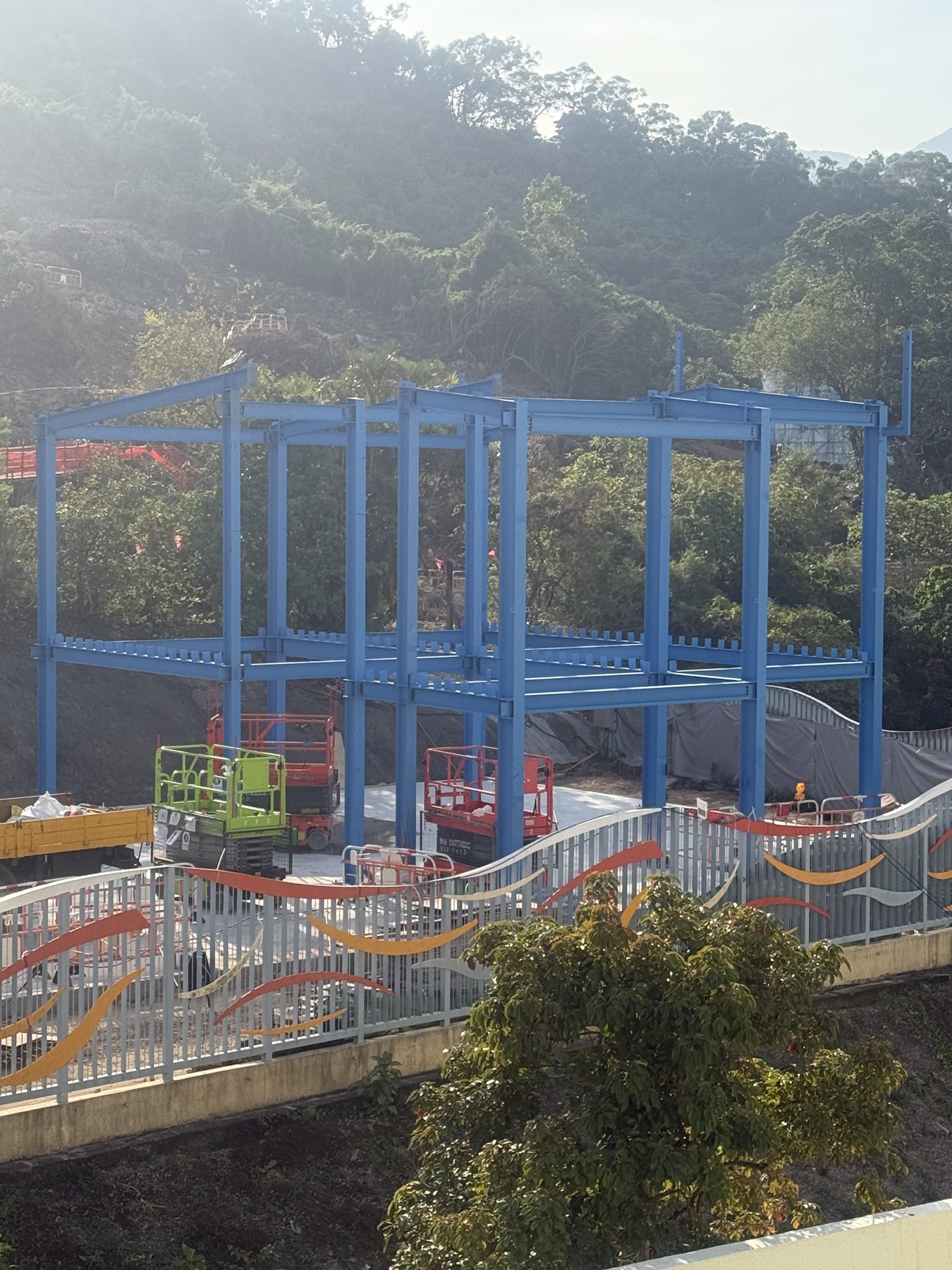Steel frame assembly on a compact hillside urban site in Hong Kong Chai Wan